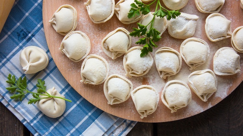 dumplings on wood board with parsley