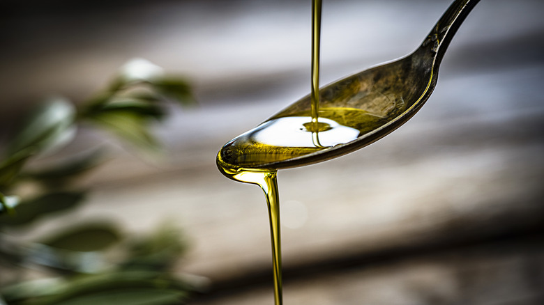 oil being poured on a spoon