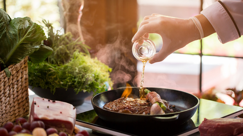 Liquid being poured onto steak