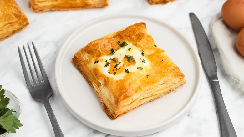 plate of savory breakfast puff with fork and knife