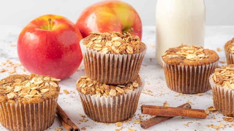 apple cinnamon muffins with apple, cinnamon sticks, and milk