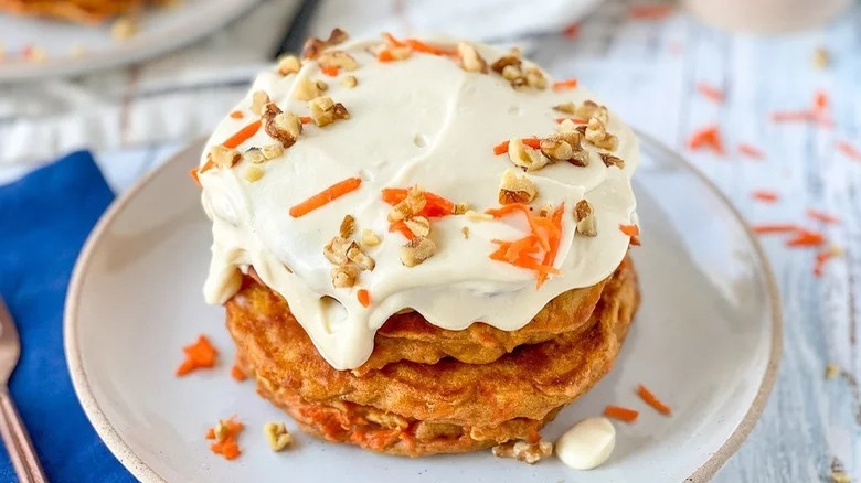 plate of carrot cake pancakes with cream cheese frosting