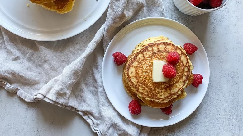 cornbread pancakes with butter and raspberries