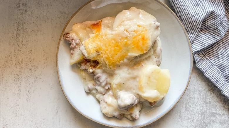 plate of creamy hamburger potato casserole with dish towel