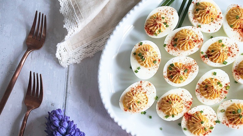 plate of deviled eggs and forks