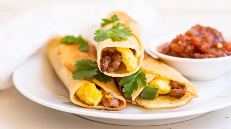 plate of fried breakfast tacos and salsa