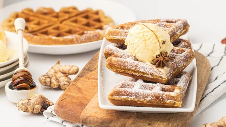 plates of gingerbread waffles with honey and ginger