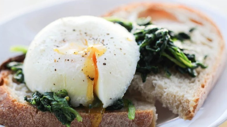 poached egg on sourdough toast with wilted spinach