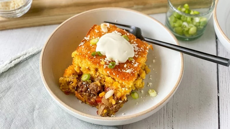 bowl of mexican cornbread casserole with fork