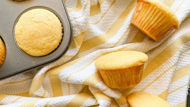 honey cornbread muffins with muffin tin and yellow towel