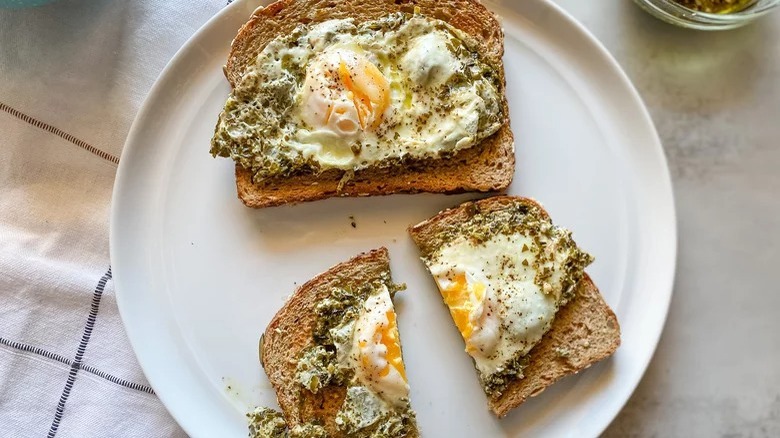 plate of pesto eggs on toast