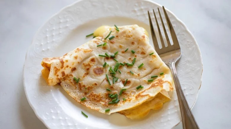 savory eggless crepe on plate with fork