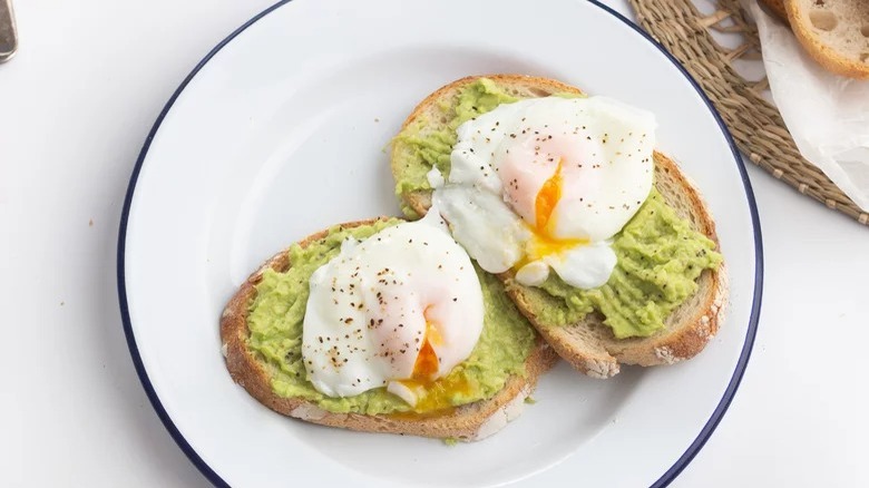 plate of avocado toast with poached eggs