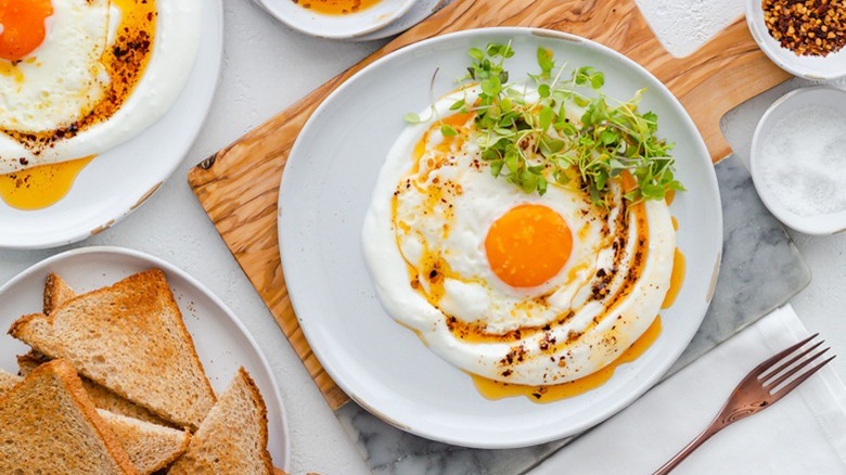 plate of turkish eggs with toast and fork