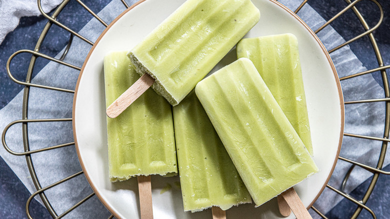 avocado popsicles on white plate