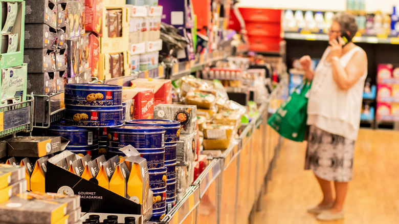 Person shopping by store shelves at Aldi