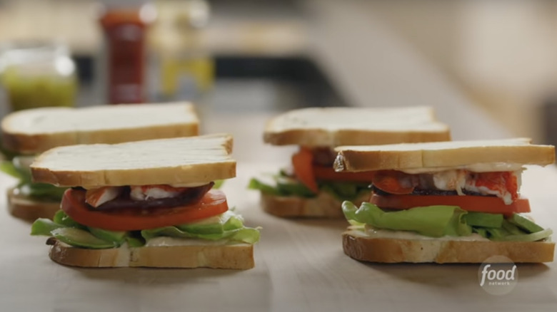 Lobster BLT sandwiches on wooden board