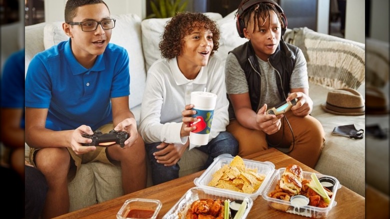 Kids playing video games and eating Chili's