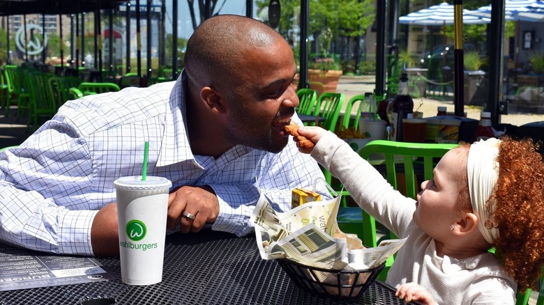 father and daughter eating Wahlburgers