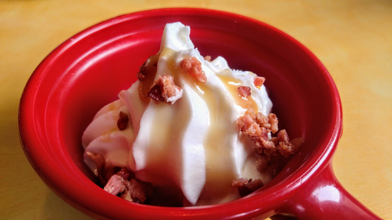 vanilla soft serve topped with caramel sauce and bacon