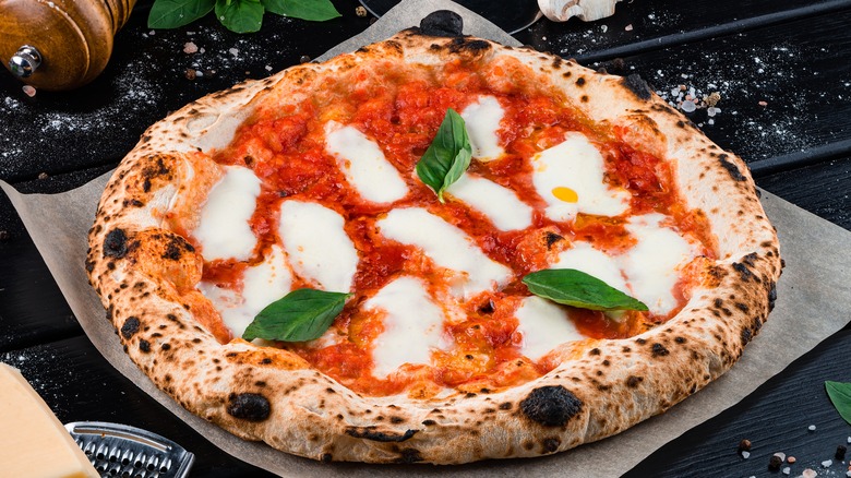 unsliced round Neapolitan pizza