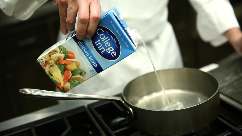 pouring store-bought chicken broth