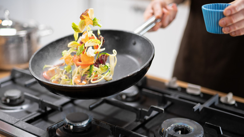 sauteeing vegetables in pan