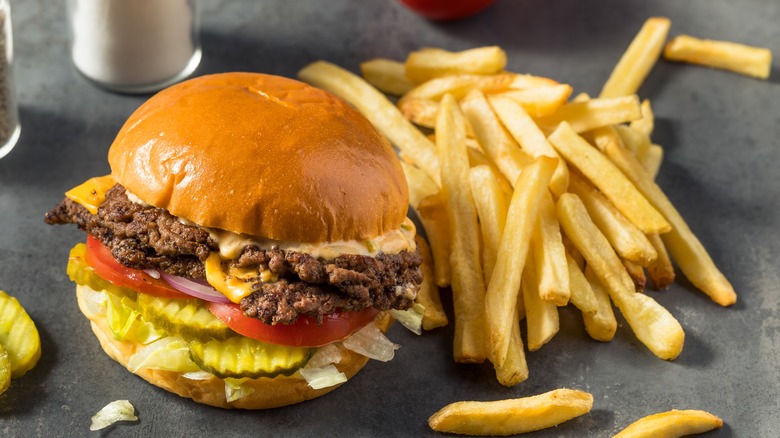 Burger and fries on black table