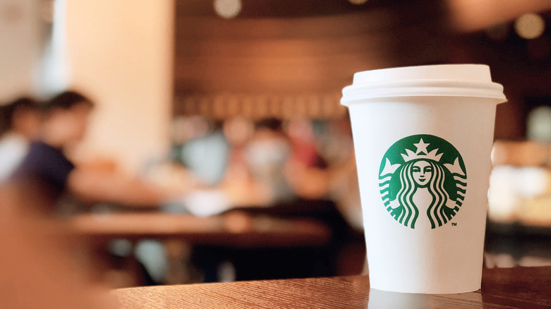 Starbucks coffee cup on table 