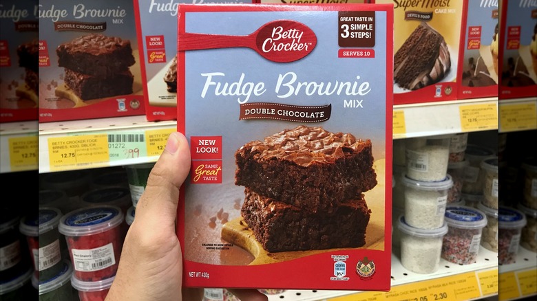 hand holding brownie mix