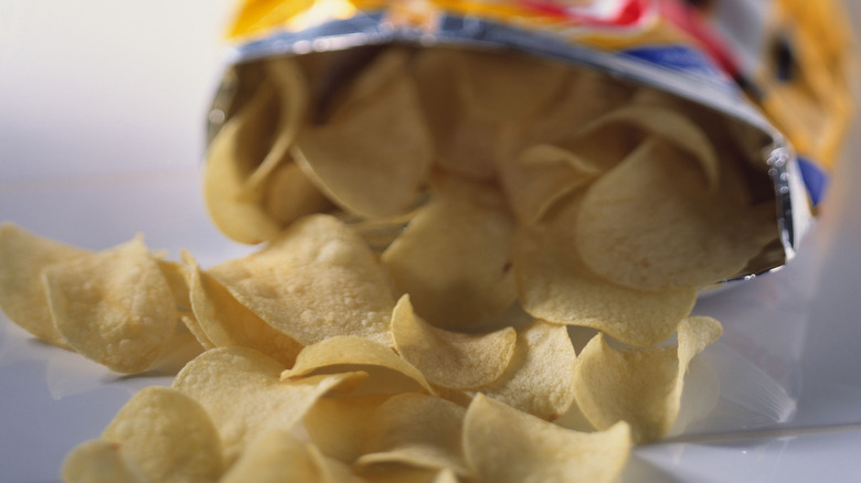 bag of opened chips spilling on to a table