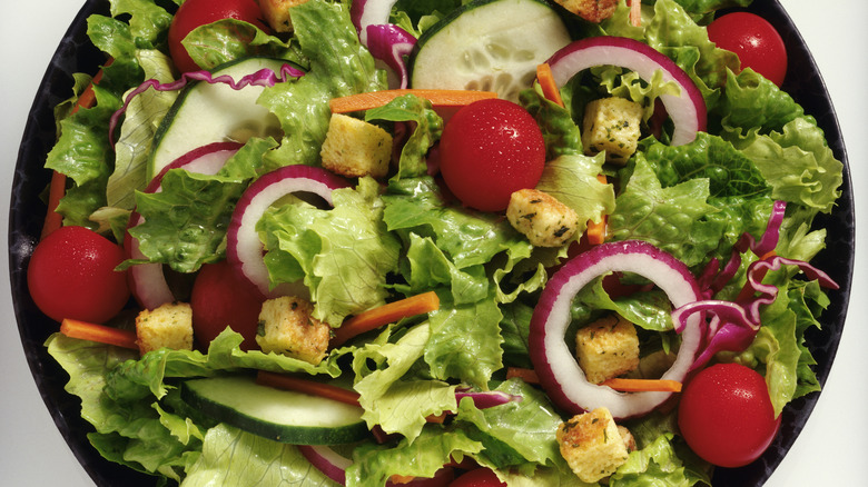 salad bowl full of lettuce and colorful vegetables