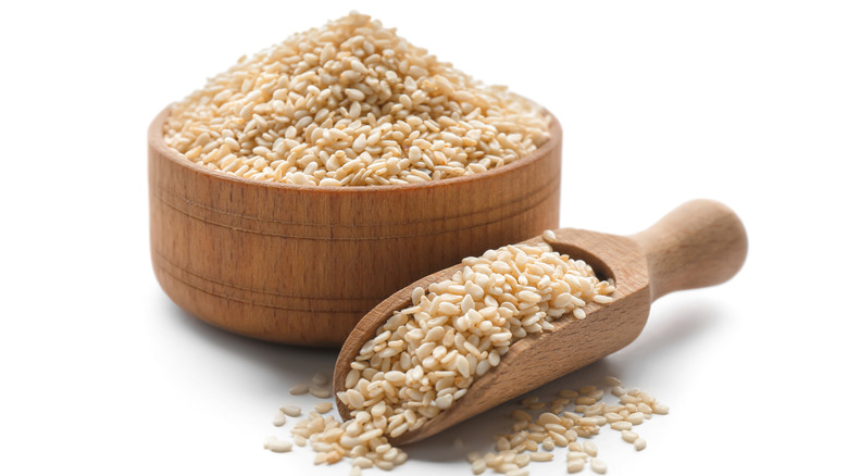 Wooden bowl of sesame seeds and scoop