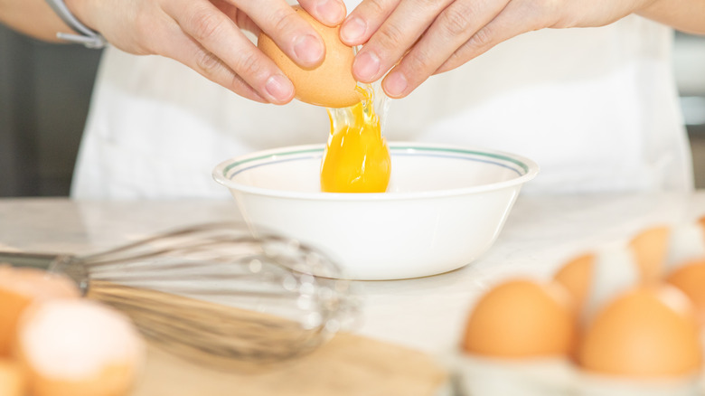 cracking egg into bowl