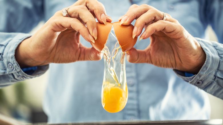 Woman cracking open an egg