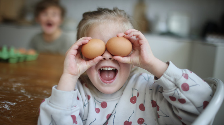 Girl playing with eggs