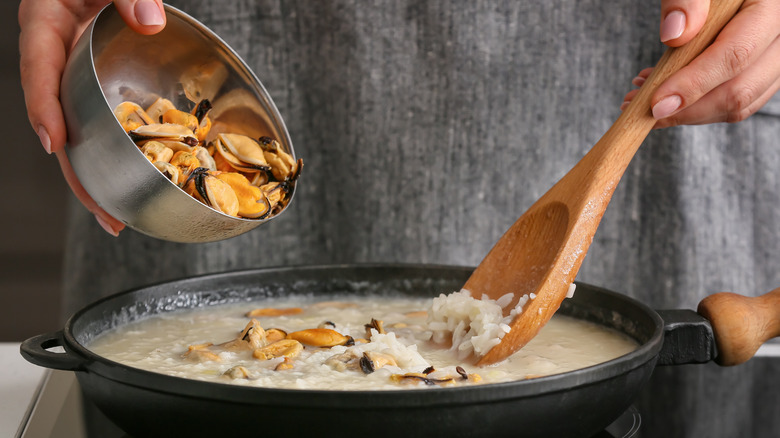 adding ingredients to risotto