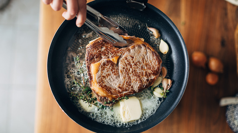 Chef searing steak