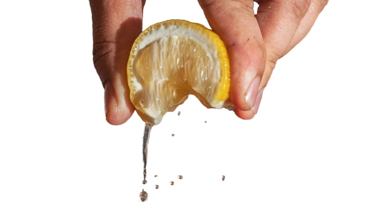 person squeezing a lemon