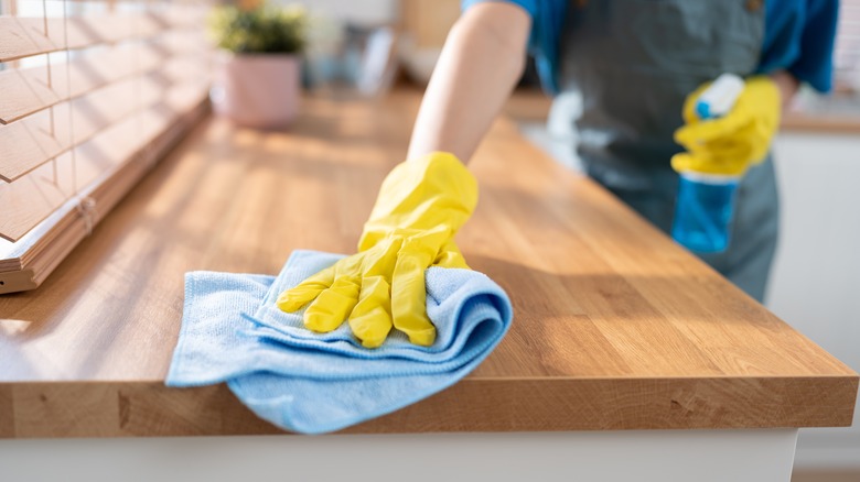 hand in gloves cleaning chicken