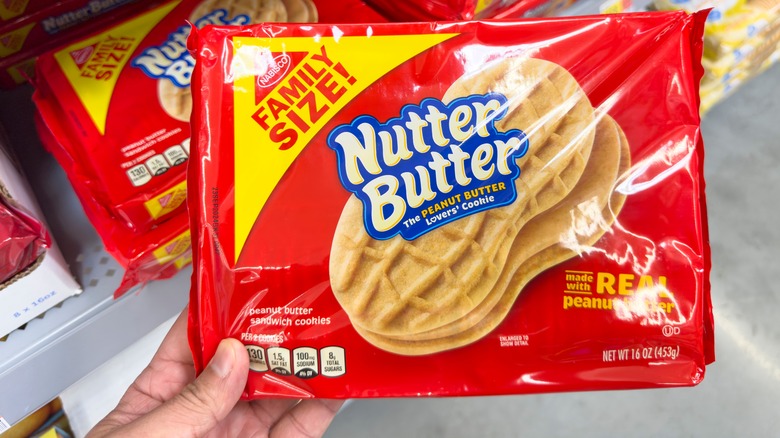 Hand holding red packet of Nutter Butters