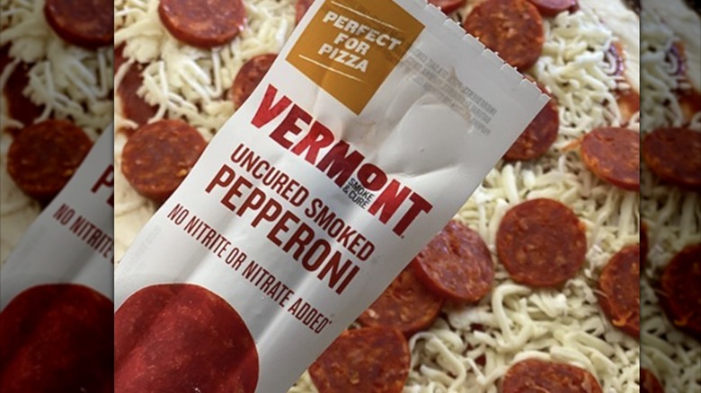 Package of Vermont Smoke & Cure pepperoni with pizza in background