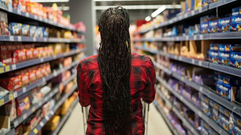 person pushing cart in grocery store