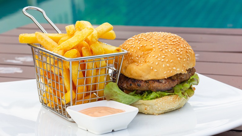 burger and fries with sauce