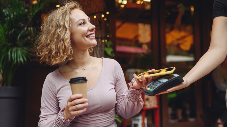 Woman paying for her coffee