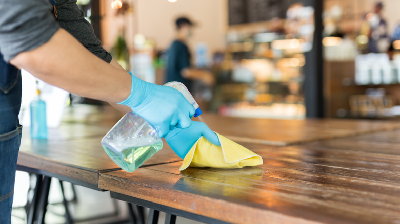 Barista cleaning table