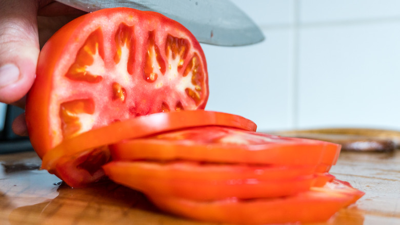 chef slicing tomatoes