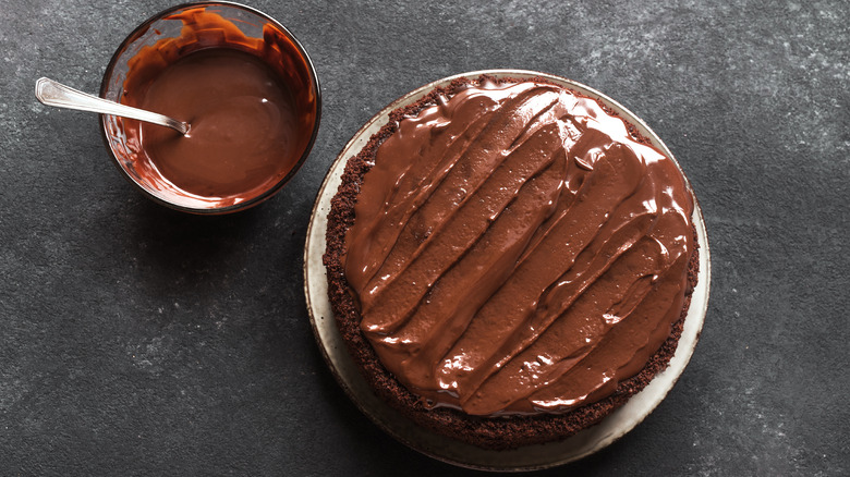 Chocolate cake with bowl of ganache