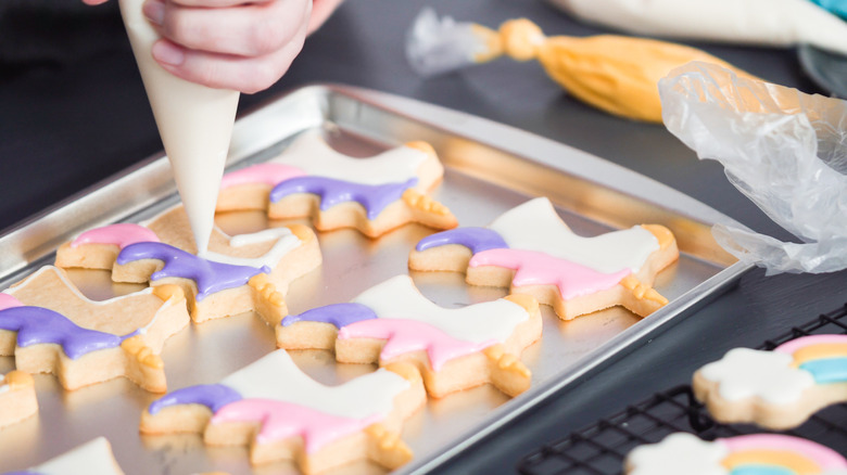 piping royal icing on sugar cookies