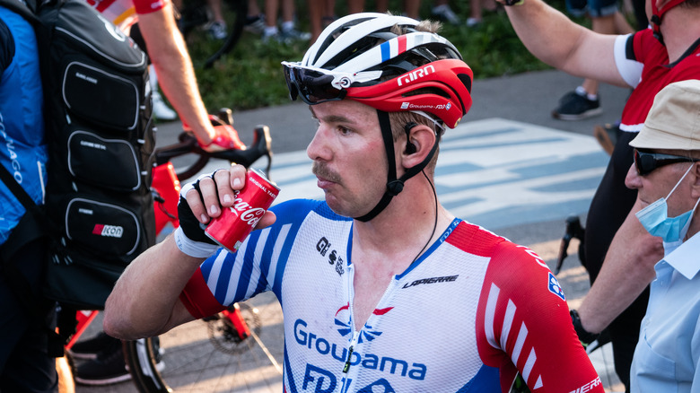 bike rider drinks coca-cola